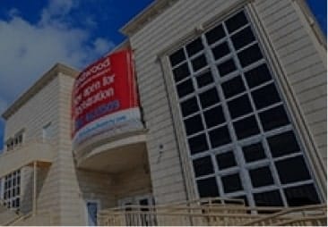 An image of a building with a sign on it.